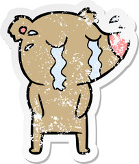distressed sticker of a cartoon crying bear