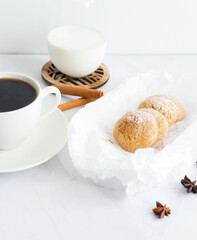 
Photo of oatmeal cookies, cookies, cinnamon, black coffee. on a white table