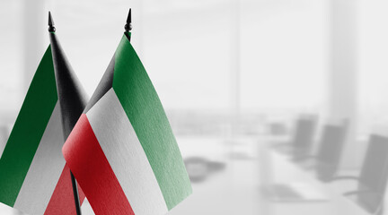 Small flags of the Kuwait on an abstract blurry background