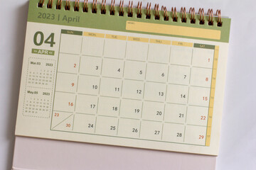 Desktop calendar for April 2023 on a light background.