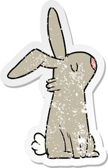 distressed sticker of a cartoon rabbit