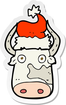 sticker of a cartoon cow wearing christmas hat