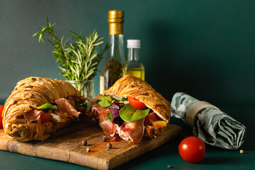Fresh aromatic full grain croissant with jamon or prosciutto, eggs, cheese, tomatoes and salad...