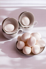 Chicken eggs on a plate. We are preparing for Easter. Chicken eggs in a cup. Eggs on a white background