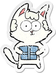 distressed sticker of a happy cartoon cat with present