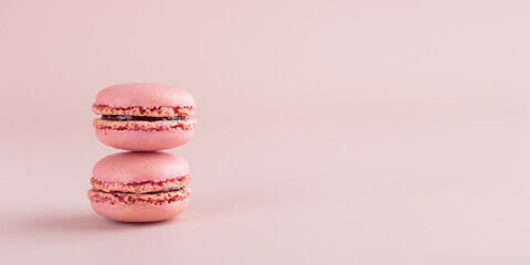 Two pink colored macaroons on pink background. Gift for 8 March, International Women's Day, Valentine Day