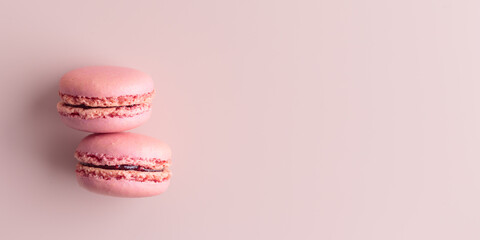 Two pink colored macaroons on pink background. Gift for 8 March, International Women's Day, Valentine Day
