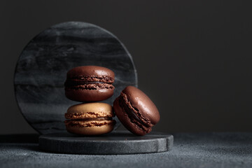 Chocolate eco handmade natural macaroons on dark background in the darkmood style