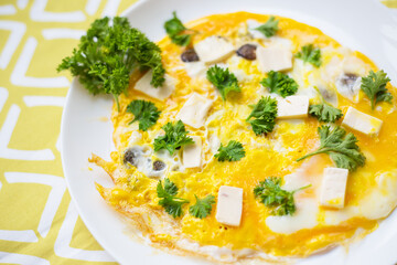 Scrambled eggs with fresh herbs on a plate