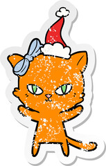 cute distressed sticker cartoon of a cat wearing santa hat