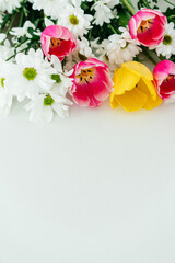 Bouquet of flowers on a white background place for text vertically
