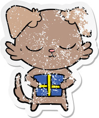 distressed sticker of a cute cartoon dog with christmas present