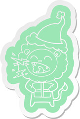 cartoon  sticker of a roaring lion with gift wearing santa hat