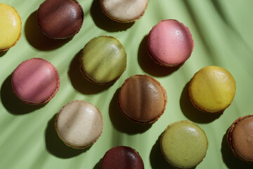Colorful pastel eco handmade macaroons on green background with a shadow. Gift for 8 March, International Women's Day, Valentine Day