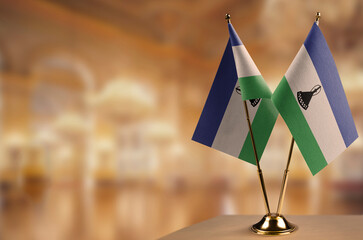 Small flags of the Lesotho on an abstract blurry background