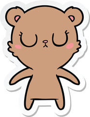 sticker of a peaceful cartoon bear cub