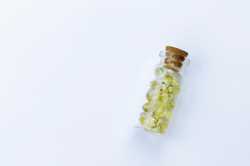 Glass bottle with yellow capsule pills