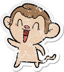 distressed sticker of a cartoon laughing monkey
