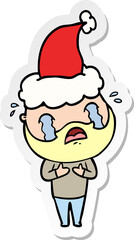 sticker cartoon of a bearded man crying wearing santa hat