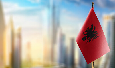 A small Albania flag on an abstract blurry background