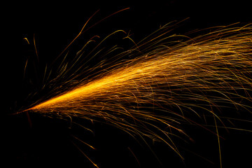 red fast-flying sparks from angle grinders on black background