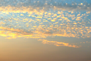 Brightly colored sky clouds, and there is a beautiful sunlight that hits clouds, perfect to be used as a background