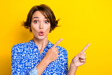 Photo of funky excited young lady wear print shirt showing two fingers empty space isolated yellow color background