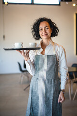 Fototapeta na wymiar One mature woman caucasian waitress at cafe or restaurant carry tray