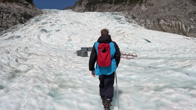 Tourists hikes up a glacier towards basecamp 
