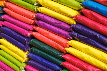 12 March 2023, Pune, India, Dry colours packed in plastic pack placed at market shop for sale for Indian Festival Holi. Holi is traditional Indian festival of colours.