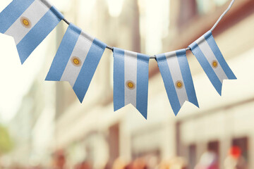 A garland of Argentina national flags on an abstract blurred background