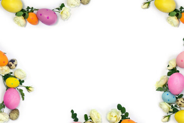 Fototapeta na wymiar Easter decoration. Easter frame of colored easter eggs and white roses flowers on white background with space for text. Top view, flat lay