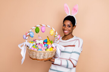 Photo of cute millennial short hairdo lady hold sweets wear white sweater ears isolated on beige color background