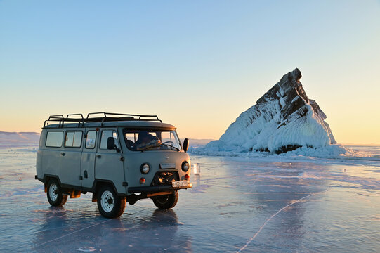 UAZ 452 Car with Elenka Island as Background During Evening Twilight at Frozen Lake Baikal