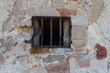 Small Rusty Iron Window with Bars in Montjuic Castle in Barcelona, Spain