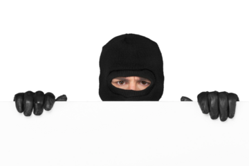 Man in black mask and black clothes looks out of the corner