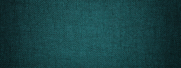 Dark emerald background from textile material with wicker pattern, and vignette. Structure of green...