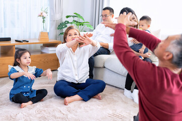 The family have fun relax engaged in fitness yoga at home using online instruction from laptop