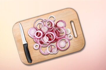 Fresh tasty onions on wooden board,