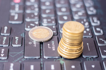 A column of coins on a computer keyboard.
