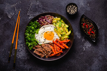 Traditional Korean dish Bibimbap: rice with vegetables beef and egg.