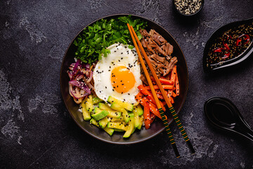 Traditional Korean dish Bibimbap: rice with vegetables beef and egg.