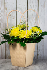 Flowers in a basket. Bouquet of yellow chrysanthemums