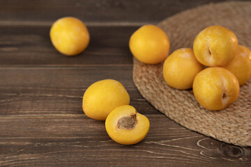 Yellow plums on a wood background. Fresh BIO fruits.