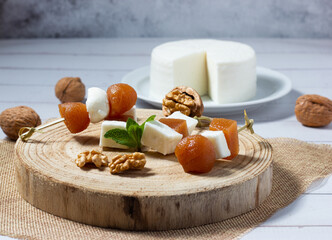 Close-up of small skewers of fresh goat cheese and quince jelly with walnuts. Typical food from Spain.