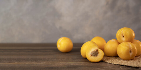 Yellow plums on a wood background. Fresh BIO fruits.