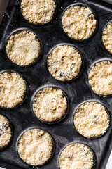 many uncooked homemade yellow oatmeal cookies on metal sheet