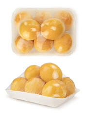 Yellow plums warped in plastic. Fresh fruits in plastic box. Yellow plums.