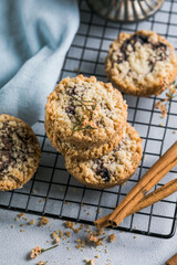 round festive pastry buiscuits cookies  with a raspberry jam on a light grey background.