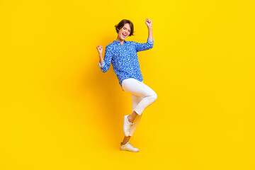 Fototapeta na wymiar Full length photo of lovely young lady excited celebrate promotion dressed stylish smart casual look isolated on yellow color background